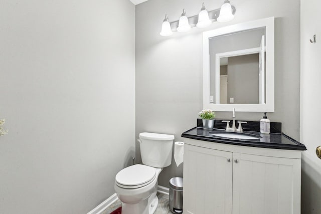 992 Hidden Lake Dr, Buffalo Grove, IL 60089 - half bathroom with toilet, vanity, baseboards, and wood finished floors