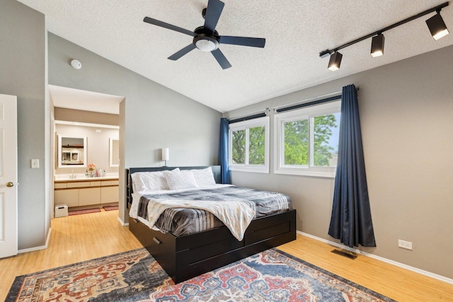 992 Hidden Lake Dr, Buffalo Grove, IL 60089 - bedroom with vaulted ceiling, light wood-type flooring, a textured ceiling, ceiling fan, and baseboards
