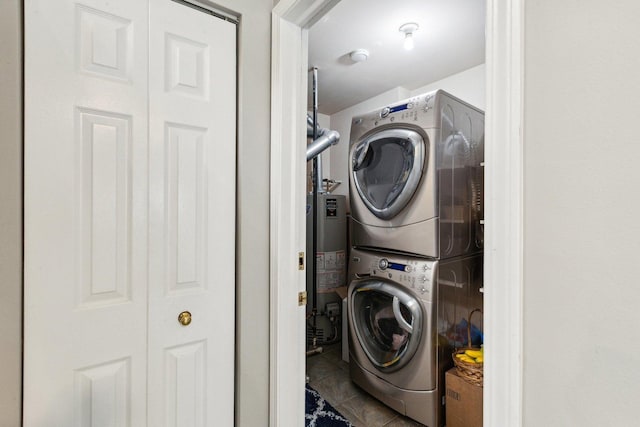 992 Hidden Lake Dr, Buffalo Grove, IL 60089 - laundry room featuring stacked washer / drying machine, water heater, and tile patterned floors