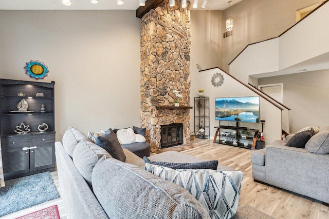 992 Hidden Lake Dr, Buffalo Grove, IL 60089 - living area with wood finished floors, a stone fireplace, and a high ceiling