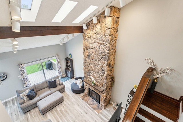 992 Hidden Lake Dr, Buffalo Grove, IL 60089 - living area featuring a skylight, lofted ceiling, wood finished floors, track lighting, and a fireplace