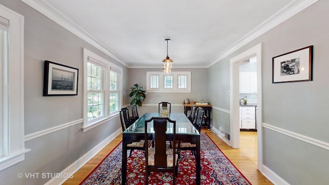 4627 S Wolf Rd, Western Springs, IL 60558 - dining area featuring light wood-type flooring, baseboards, and crown molding
