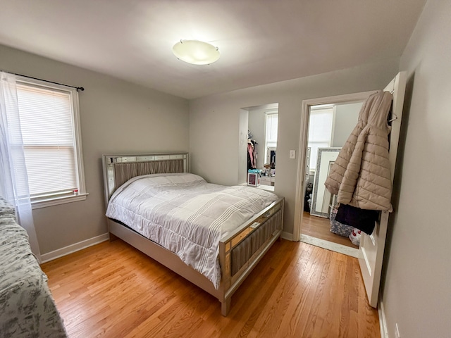 8137 Keating Ave, Skokie, IL 60076 - bedroom featuring light wood-style floors, multiple windows, baseboards, and a closet