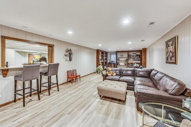 6425 N Tower Ct, Lincolnwood, IL 60712 - living area featuring light wood finished floors, baseboards, wood walls, recessed lighting, and bar