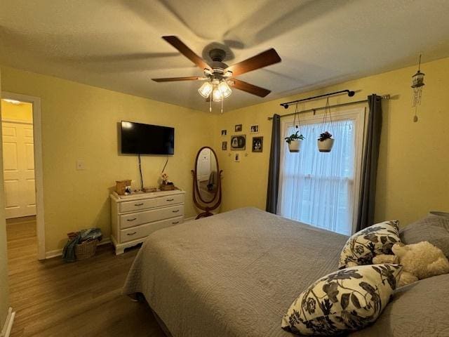 1521 E Stonehenge Dr Unit 1521, Sycamore, IL 60178 - bedroom with dark wood finished floors, ceiling fan, and baseboards