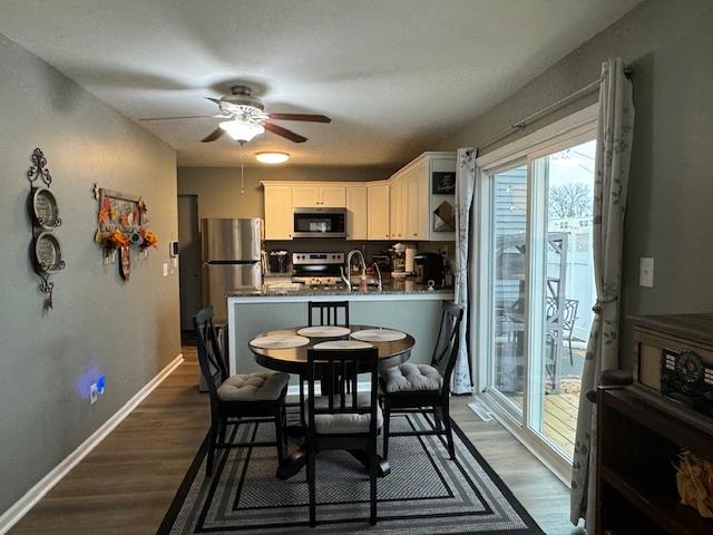 1521 E Stonehenge Dr Unit 1521, Sycamore, IL 60178 - dining area with a ceiling fan, dark wood finished floors, and baseboards