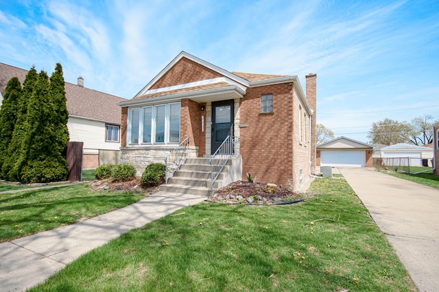 5533 S Menard Ave, Chicago, IL 60638 - view of front of home featuring an outbuilding, brick siding, and a front lawn