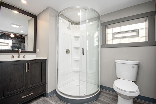 5533 S Menard Ave, Chicago, IL 60638 - bathroom featuring baseboards, wood finished floors, a stall shower, and toilet