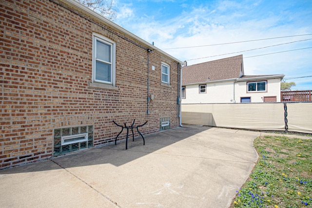 5533 S Menard Ave, Chicago, IL 60638 - view of property exterior with brick siding, a patio, and fence