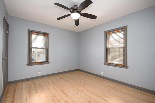 5533 S Menard Ave, Chicago, IL 60638 - unfurnished room with light wood-style floors, baseboards, and ceiling fan