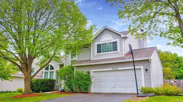 36164 N Bridlewood Ave, Gurnee, IL 60031 - traditional home with driveway, a chimney, a shingled roof, and a garage