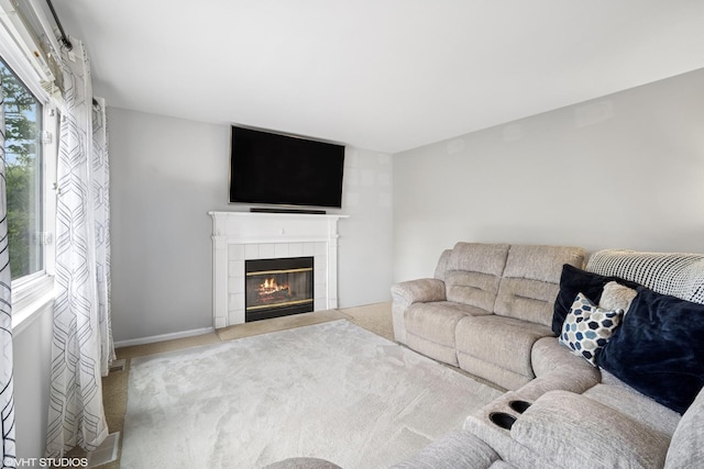 36164 N Bridlewood Ave, Gurnee, IL 60031 - living room featuring carpet floors, a tiled fireplace, and baseboards