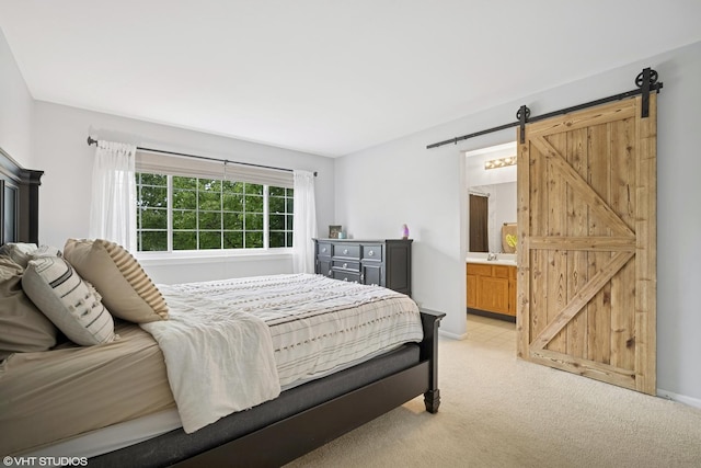 36164 N Bridlewood Ave, Gurnee, IL 60031 - bedroom featuring light carpet, a barn door, ensuite bathroom, baseboards, and a sink