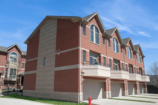 view of property featuring a garage and driveway