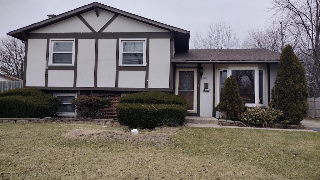 3702 Peach Grove Ln, Hazel Crest, IL 60429 - view of front facade with stucco siding and roof with shingles