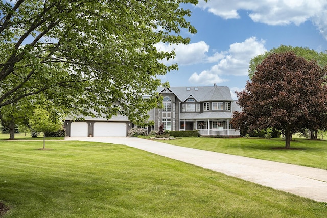 56 Huntsman Ln, Plano, IL 60545 - view of front facade with a front yard, driveway, and covered porch