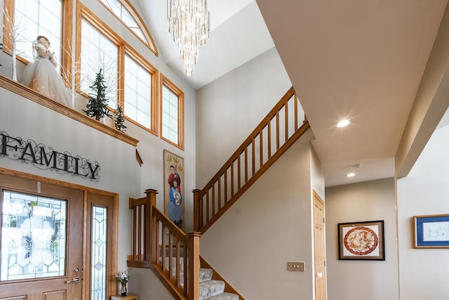 56 Huntsman Ln, Plano, IL 60545 - foyer featuring a towering ceiling, stairs, a chandelier, and recessed lighting