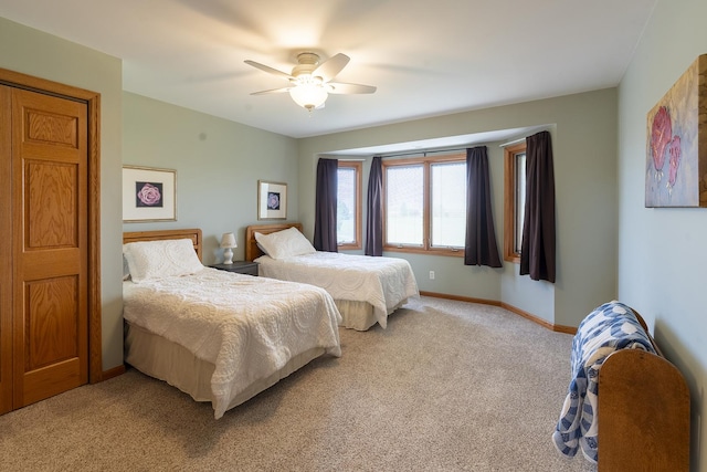 56 Huntsman Ln, Plano, IL 60545 - bedroom with light carpet, baseboards, and ceiling fan