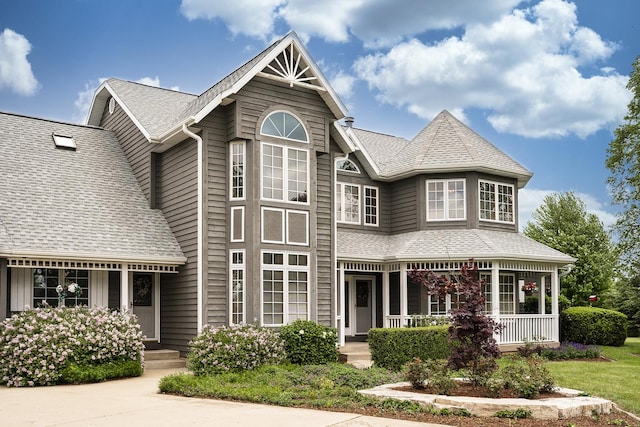 56 Huntsman Ln, Plano, IL 60545 - view of front facade with roof with shingles and a porch