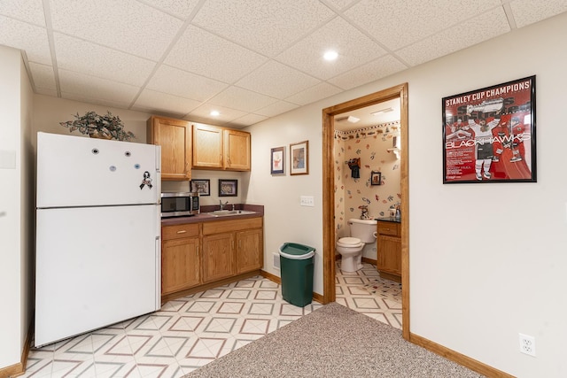56 Huntsman Ln, Plano, IL 60545 - kitchen with freestanding refrigerator, stainless steel microwave, a paneled ceiling, a sink, and recessed lighting
