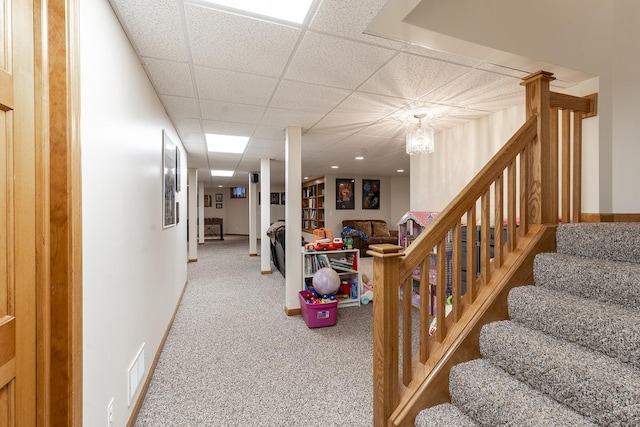 56 Huntsman Ln, Plano, IL 60545 - staircase featuring carpet flooring, a paneled ceiling, and baseboards