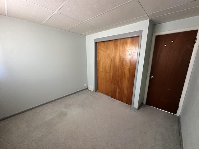 10071 Frontage Rd Unit F, Skokie, IL 60077 - unfurnished bedroom featuring a paneled ceiling, carpet, a closet, and baseboards