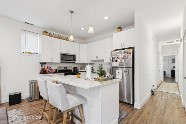 1845 N Marshfield Ave, Chicago, IL 60622 - kitchen with appliances with stainless steel finishes, baseboards, wood finished floors, and recessed lighting