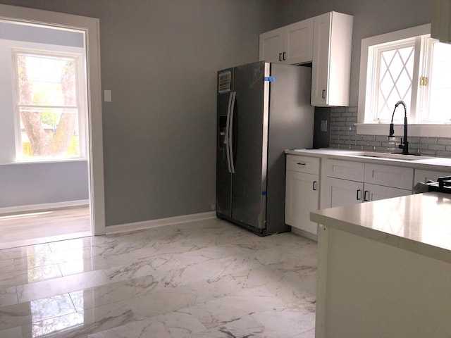 9715 S Ave N Ave, Chicago, IL 60617 - kitchen featuring a sink, stainless steel refrigerator with ice dispenser, white cabinets, and baseboards