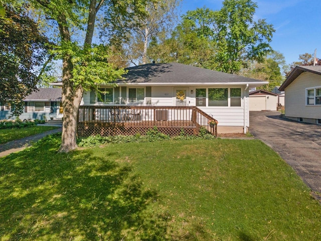 view of front of house with an outdoor structure, a front yard, and a garage