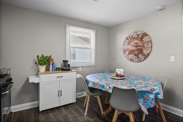 dining room with baseboards and wood tiled floors