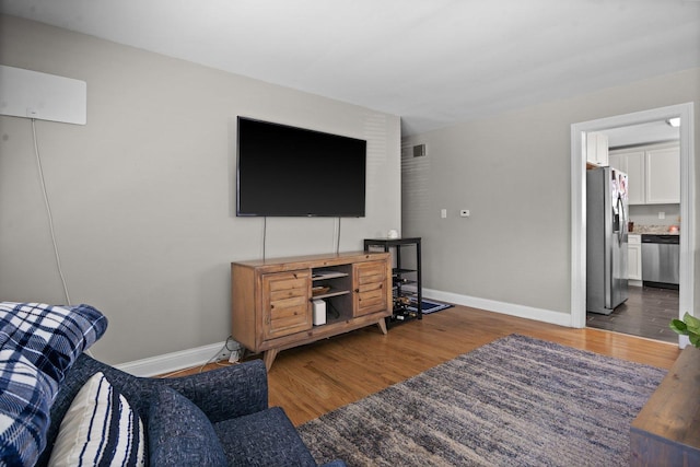 living room with wood finished floors and baseboards
