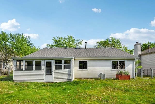 rear view of property with a shingled roof