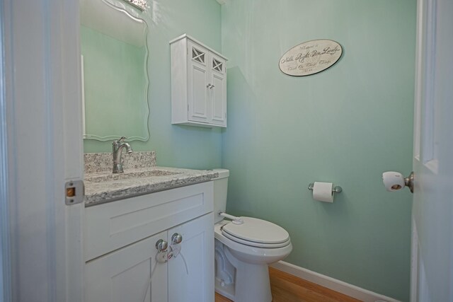 1706 Childs St, Wheaton, IL 60187 - bathroom with toilet, vanity, wood finished floors, and baseboards