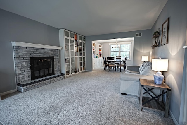 1706 Childs St, Wheaton, IL 60187 - carpeted living room with a chandelier, a brick fireplace, and baseboards