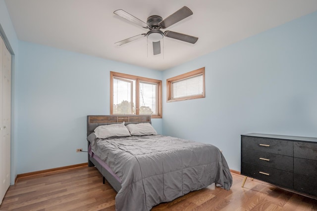 8440 Anvil Pl, Tinley Park, IL 60487 - bedroom with a closet, light wood-style flooring, a ceiling fan, and baseboards