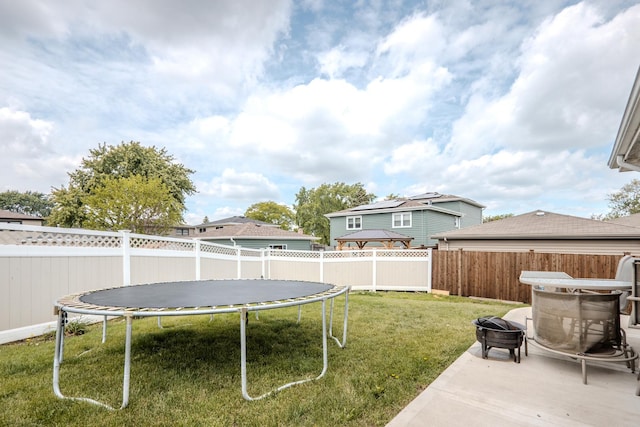8440 Anvil Pl, Tinley Park, IL 60487 - view of yard featuring a trampoline, a fire pit, and a patio area