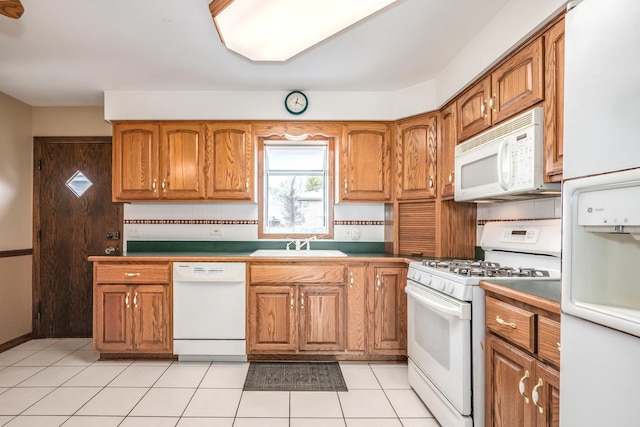 8440 Anvil Pl, Tinley Park, IL 60487 - kitchen featuring white appliances, brown cabinetry, a sink, and light tile patterned floors
