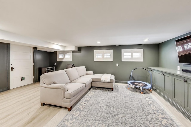 living room featuring light wood finished floors, healthy amount of natural light, and recessed lighting