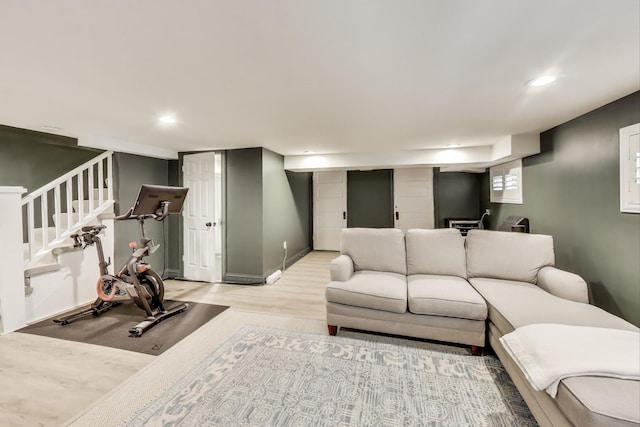 living area featuring wood finished floors, stairway, and recessed lighting