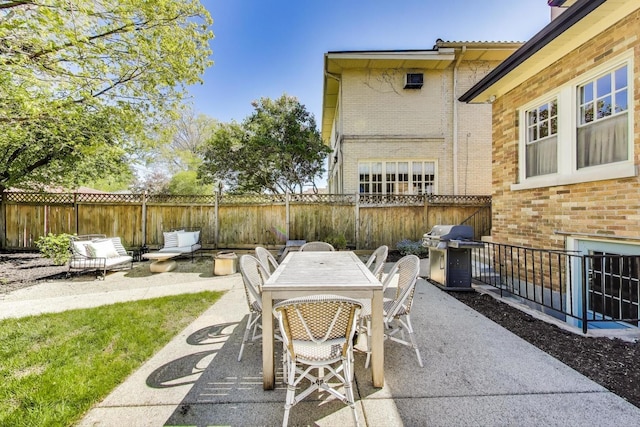 view of patio / terrace featuring area for grilling, a fenced backyard, and outdoor dining area