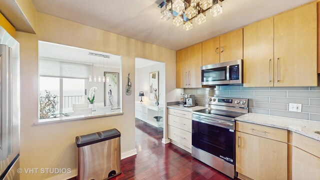 6033 N Sheridan Rd Unit 27B, Chicago, IL 60660 - kitchen featuring appliances with stainless steel finishes, light brown cabinetry, dark wood-type flooring, and a chandelier