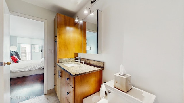 6033 N Sheridan Rd Unit 27B, Chicago, IL 60660 - bathroom featuring toilet, vanity, ensuite bath, and tile patterned floors