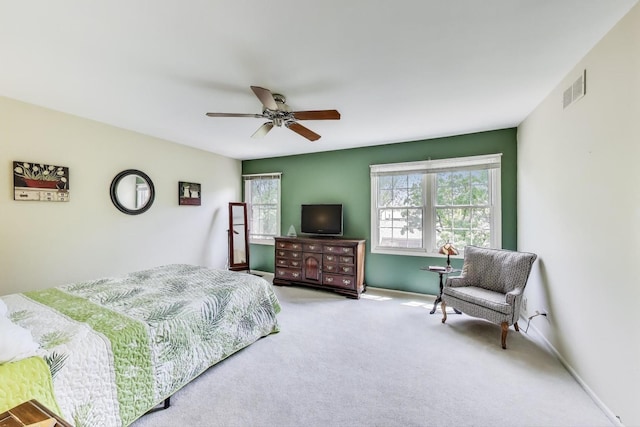 bedroom with multiple windows, carpet, and a ceiling fan