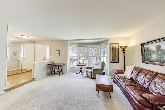 carpeted living room featuring baseboards
