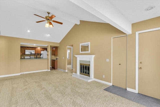 1109 Pomona Dr Unit 1109, Champaign, IL 61822 - unfurnished living room featuring beam ceiling, light colored carpet, ceiling fan, a fireplace, and high vaulted ceiling