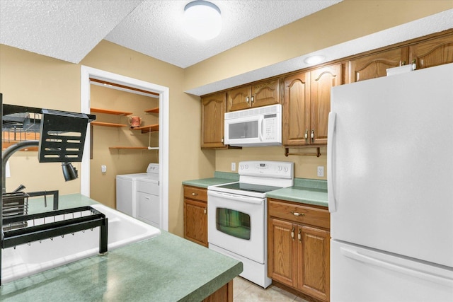 1109 Pomona Dr Unit 1109, Champaign, IL 61822 - kitchen with white appliances, washing machine and clothes dryer, a textured ceiling, brown cabinets, and light tile patterned flooring
