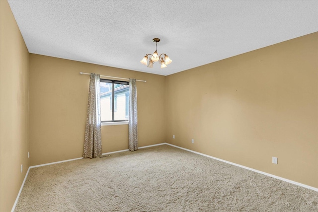 1109 Pomona Dr Unit 1109, Champaign, IL 61822 - spare room featuring a chandelier, carpet floors, and a textured ceiling