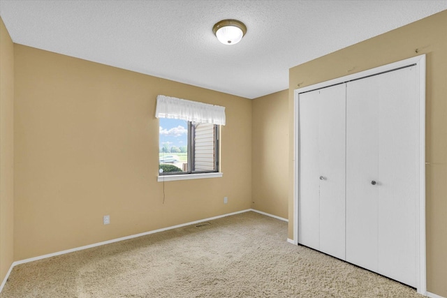 1109 Pomona Dr Unit 1109, Champaign, IL 61822 - unfurnished bedroom with carpet flooring, a closet, and a textured ceiling