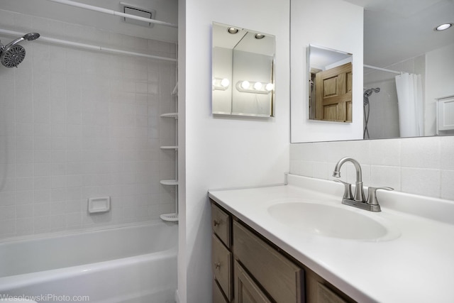 full bath with backsplash, shower / bath combo with shower curtain, and vanity