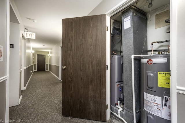 utility room featuring water heater and hybrid water heater